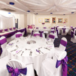 The Central Avenue Suite at Mercure Bolton Georgian House Hotel set up ready for a wedding breakfast, white linen, purple sashes and centrepieces