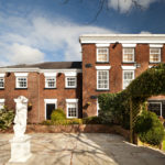 Exterior shot of Mercure Bolton Georgian House Hotel, building and statue in garden